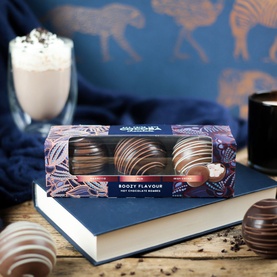 Cocoba Boozy Flavoured Hot Chocolate Bombes 150g, three milk, dark and white chocolate domes in gift box, styled with hot chocolate drink
