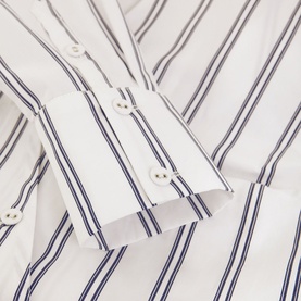 Phase Eight Ashlyn Asymmetric Striped Blouse in white cotton, close-up of navy striped cuff with white button fastening detail