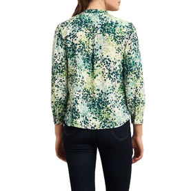 Model wearing Hobbs Beatrix Floral Blouse in white with green floral print, band collar, half button placket, three-quarter sleeves