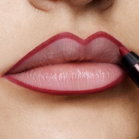 TOM FORD Runway Lip Pencil shown on model's lips, defining a deep berry-red lip line with glossy nude centre
