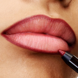 TOM FORD Runway Lip Pencil applied to model's lips, shown in a deep rosy-pink shade with precise liner definition
