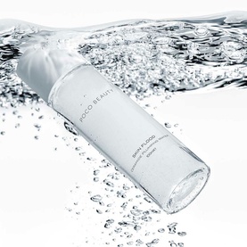 POCO BEAUTY Skin Flood Ceramide Plumping Water 100ml clear bottle, shown emerging from a splash of water droplets