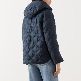 Model wearing Marc O Polo Quilted Cape Jacket in blue, showing diamond-quilted back, attached hood, and long sleeves, styled with light blue jeans