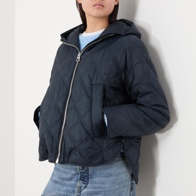 Model wearing Marc O Polo Quilted Cape Jacket in blue, with hood, front zip fastening and quilted finish, styled with blue jeans