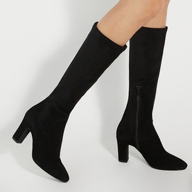 Model wearing Dune Simple Knee High Boots in black suede with pointed toe, block heel, fitted knee-high silhouette and side-zip fastening