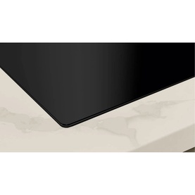 Neff N70 Aspirating Hob 80cm in black, flush-mounted on a white marble surface, showing smooth ceramic glass finish