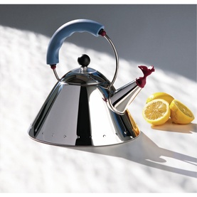Alessi Whistle Kettle in polished stainless steel with blue handle and red bird whistle spout, styled beside sliced lemons