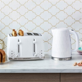 Russell Hobbs Honeycomb Toaster 4 Slice White with matching white kettle on kitchen counter, geometric tiled backdrop