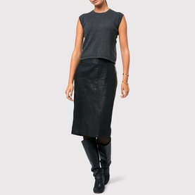 Model wearing Helen McAlinden Marlena Cashmere Top in grey with crew neck and cap sleeves, styled with black leather midi skirt and knee-high boots