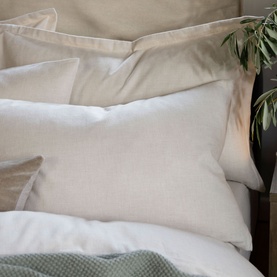 Christys Flannel Marl Standard Pillowcase Set of Two in cream, soft brushed cotton with classic border detail, styled on a made bed