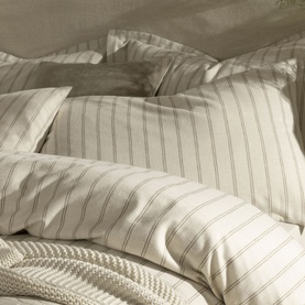 Christys Flannel Striped Duvet Set in cream, featuring classic tonal stripes and soft brushed cotton finish, styled with matching pillowcases