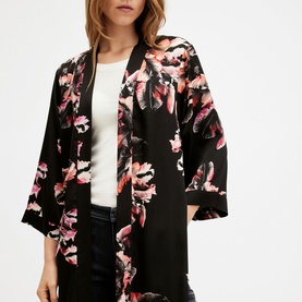 Model wearing All Saints Carine Floral Kimono in pink, black open-front style with mid-length sleeves, styled over white top