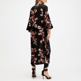 Model wearing All Saints Carine Floral Kimono in pink floral print on black, open front, midi length, styled with black trousers and heels