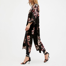 Model wearing All Saints Carine Floral Kimono in pink and black floral print, styled with black cropped trousers and strappy heels