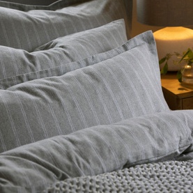 Christys Flannel Striped Duvet Set in silver, brushed cotton with tonal stripe detail, styled on a bed with pillowcases