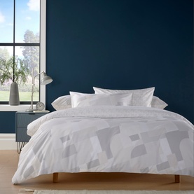 Christys Blocks Duvet Set in white with printed geometric design, styled on a double bed with matching pillowcases