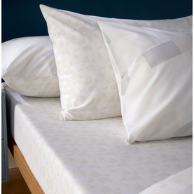 Christys Blocks Duvet Set White, 100% cotton with subtle printed geometric pattern, styled on a bed with two pillowcases