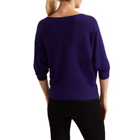 Model wearing Phase Eight Cristine Knitted Sweater in purple, showing back view with batwing three-quarter sleeves and slash neckline