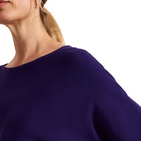 Model wearing Phase Eight Cristine Knitted Sweater in purple, featuring a slash neckline and batwing sleeves, close-up detail view
