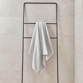 Christys Prism Towel Whitewash in white draped over a black ladder rack, featuring subtle tonal stripe detail and soft finish