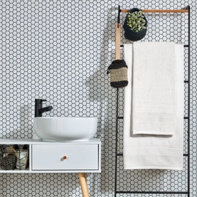 Christys Prism Towel Whitewash in white, draped on a ladder rail in a tiled bathroom with soft tonal stripe detail visible