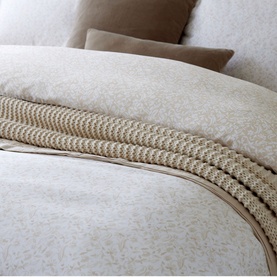 Christys Daisy Meadow Duvet Set Hazelnut in brown cotton sateen with floral print and woven piped trim detail, styled on bed