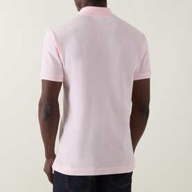 Model wearing Lacoste Heritage Logo Piqu&eacute; Polo Shirt in light pink, rear view, short sleeves with ribbed cuffs, straight hem
