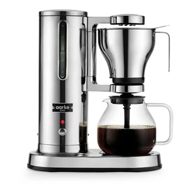Aarke Coffee Brewer in silver stainless steel with glass carafe filled with brewed coffee, polished chrome finish