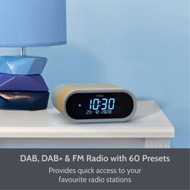 IBox Radio Silver DAB/DAB+/FM clock radio with blue LED display, styled on a white shelf beside a blue lamp
