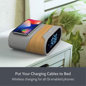 IBox Radio Silver alarm clock speaker on bedside table with wireless charging phone, wood and grey fabric finish