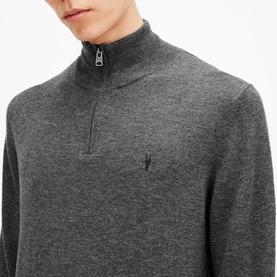 Model wearing All Saints Kilburn Half-Zip Sweater in grey marl, showing half-zip neckline and embroidered logo detail on chest
