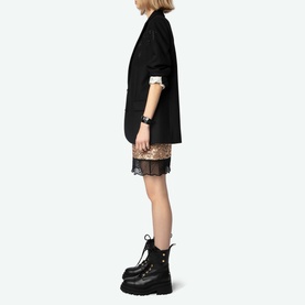 Model wearing Zadig Sequin Mini Skirt in gold with lace hem trim, styled with black oversized blazer and black lace-up platform boots