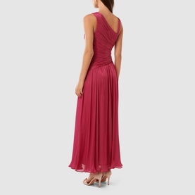 Model wearing Forever New Nya Ruched Asymmetric Dress in berry, showing pleated maxi skirt and ruched bodice from the back, styled with silver heels