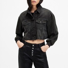 Model wearing All Saints Anders Embellished Cropped Denim Jacket in black with dropped shoulders, styled with black coated jeans