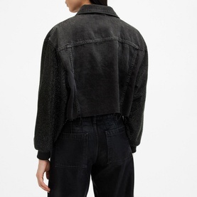 Model wearing All Saints Anders Embellished Cropped Denim Jacket in black, back view, showing embellished sleeves and rib-knit cuffs