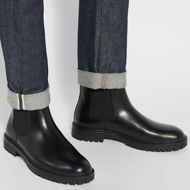 Model wearing Dune Colson Leather Chelsea Boots in black, smooth leather with elasticated side panels and chunky rubber sole