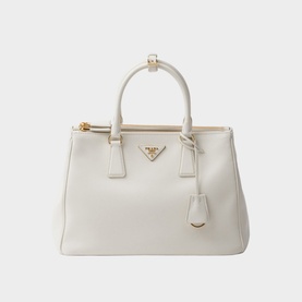 Prada Accessories Galleria Large Leather Bag in white with gold-tone hardware, twin rolled handles, triangle logo, and structured silhouette