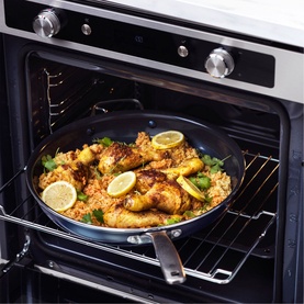 Blue Diamond Non-Stick Frypan 30cm in blue, shown in oven with chicken, rice and lemon slices, highlighting oven-safe capability