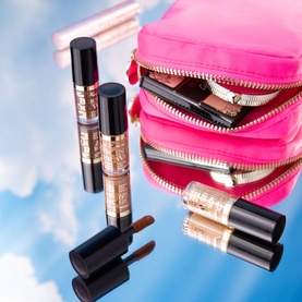 Too Faced Travel Size Born This Way Super Coverage Concealer in Natural Beige, 2ml, shown with pink makeup bag and lipstick