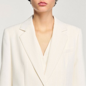 Model wearing Sandro Sequin Suit Blazer in clear, single-breasted with notch lapel, styled over a V-neck top.