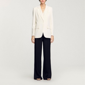 Model wearing Sandro Sequin Suit Blazer in clear with navy wide-leg trousers and open-toe heels