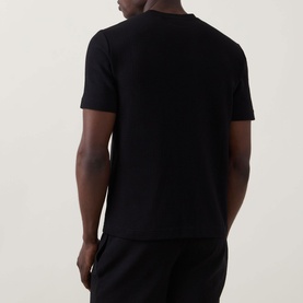 Model wearing Hugo Austin Logo Pyjama Top in black, waffle finish, round neck, short sleeves. Styled with matching black lounge bottoms.