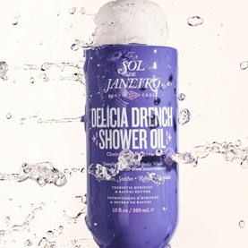 Sol de Janeiro Delicia Drench Shower Oil in purple bottle with water droplets splashing around it