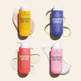 Sol De Janeiro Delicia Drench Shower Oil in blue bottle, shown alongside three other Sol De Janeiro body wash products in yellow, pink, and coral