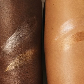 Sol De Janeiro GlowMotions Copacabana Bronze Glow Oil swatched on two skin tones, showing a shimmery bronze finish
