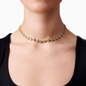 Model with Lynott Jewellery Total Glam Necklace in gold, featuring crystal-set links on 18kt gold-plated chain, worn as a choker