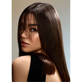 Model with glossy, sleek straight dark hair, styled to demonstrate Oribe Supershine Mirror Rinse Glass Treatment results
