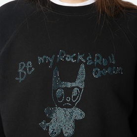 Model wearing Zadig Supper Printed Pullover Sweatshirt in black with teal rhinestone "Be My Rock N Roll Queen" devil graphic print