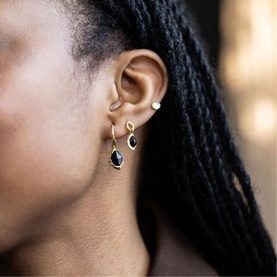 Model with Juvi Black Onyx Pebble Hook Earrings in gold vermeil with hand-cut black onyx gem drops, styled with small stud earrings