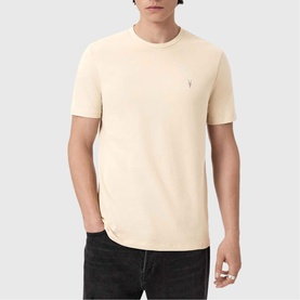 Model wearing All Saints Three-Pack Brace Ramskull Logo T-Shirt in cream, short sleeves, Ramskull logo embroidery at chest, paired with dark jeans